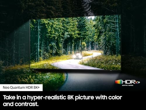 8K TV displaying a forest scene with a car on a winding road.