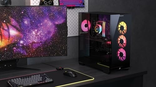 Modern gaming PC setup with colorful lights and space-themed monitor.