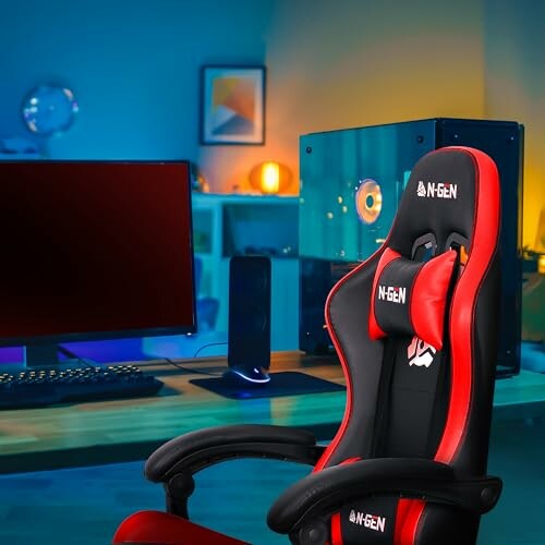 Red and black gaming chair in front of computer setup