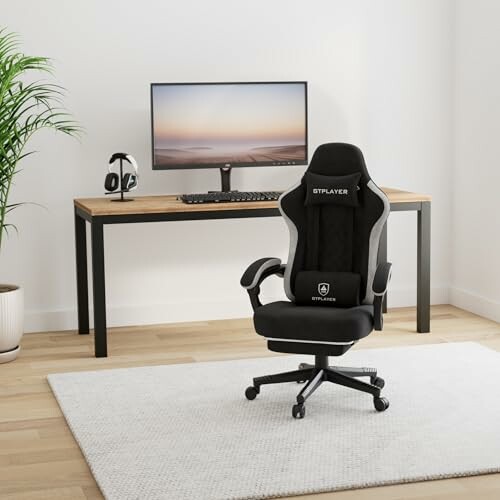 Gaming chair and desk setup with monitor and headphones.